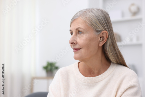 Senior woman with hearing aid at home, space for text Free Download Senior woman with hearing aid at home, space for text - GFXLoad