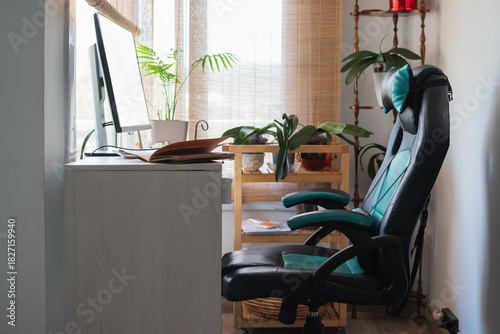 Home office workspace featuring computer desk and gaming chair