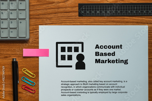 The dummy document of the Account Based Marketing is on the desk, along with a calculator and a pen.