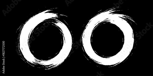 Two bold black ink circles painted with dynamic brush strokes, minimalist Japanese sumi-e style, clean background.