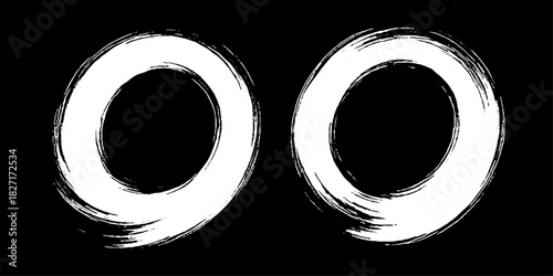 Two bold black ink circles painted with dynamic brush strokes, minimalist Japanese sumi-e style, clean background.