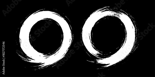 Two bold black ink circles painted with dynamic brush strokes, minimalist Japanese sumi-e style, clean background.