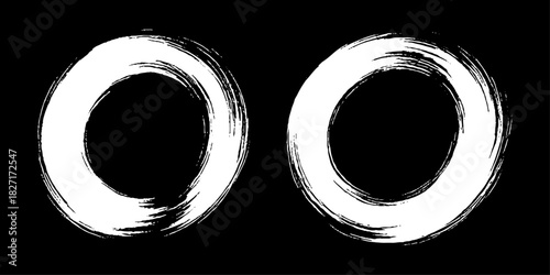 Two bold black ink circles painted with dynamic brush strokes, minimalist Japanese sumi-e style, clean background.