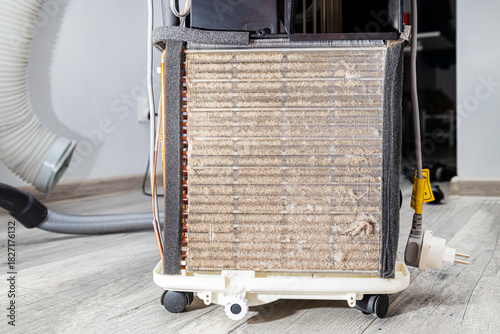 Dirty refrigerator radiator, cooler clogged with dust and dirt