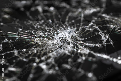 Close-up of black broken glass, beautiful patterns of broken glass, shards.