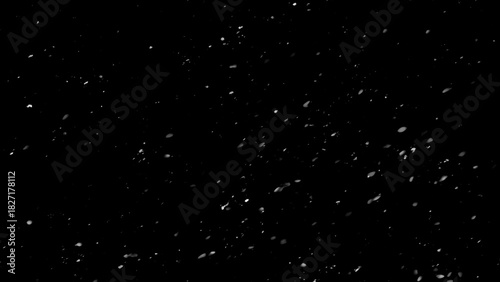 Winter freeze motion of white snow coming down, isolated on black background. Snowfall texture overlays.