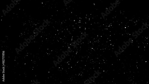 Winter freeze motion of white snow coming down, isolated on black background. Snowfall texture overlays.