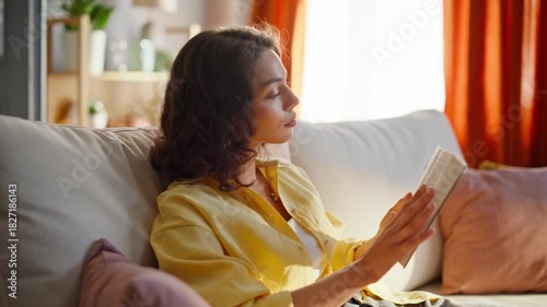 Calm reader enjoy novel at cozy couch living room at domestic weekend closeup. 