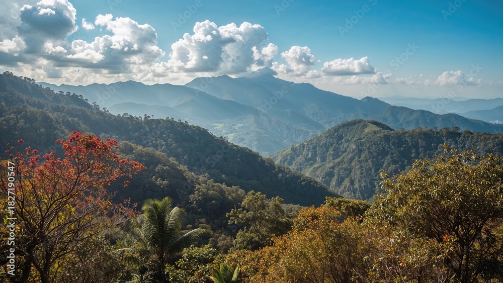 Fototapeta premium Lush green mountains and forested hills under a partly cloudy sky in a natural landscape