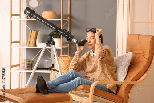 Young Asian woman using tel...