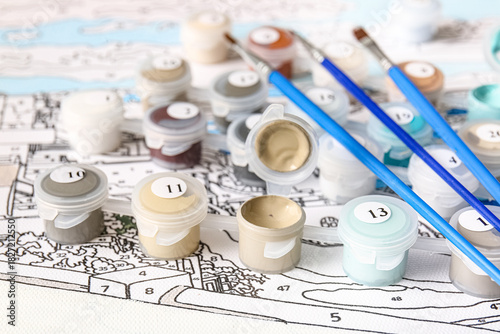 Paints and brushes on unfin...