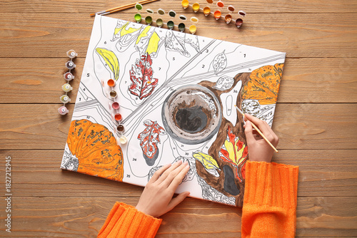 Woman paints on canvas for ...