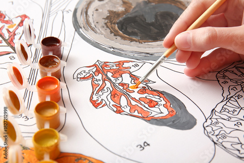Woman paints on canvas for ...