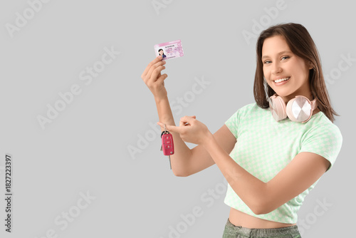 Happy young woman with driv...