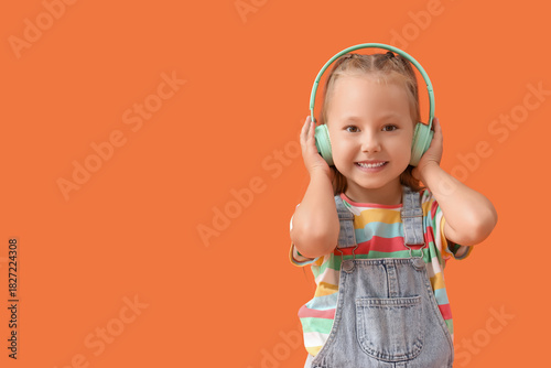 Cute little girl in headpho...