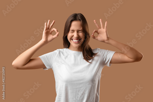 Young woman showing OK on b...