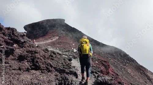 Mount Fuji, Kitayama, Fujinomiya, Shizuoka, Japan, Hiker trekking up volcanic mountain trail with backpack and walking poles