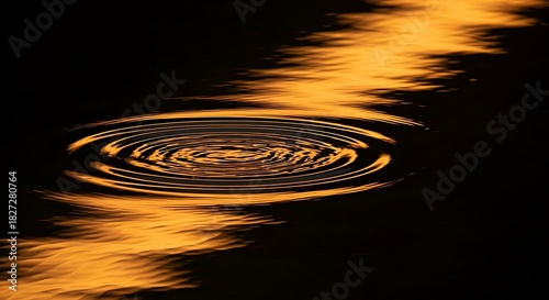 Golden water ripple pattern against a dark backdrop, light reflection