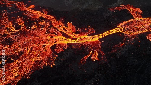 Volcanic eruption, red burning lava erupts from ground, drone fly over active volcano crater in Iceland