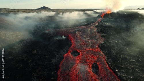 Volcanic eruption, red burning lava erupts from ground, drone fly over active volcano crater in Iceland