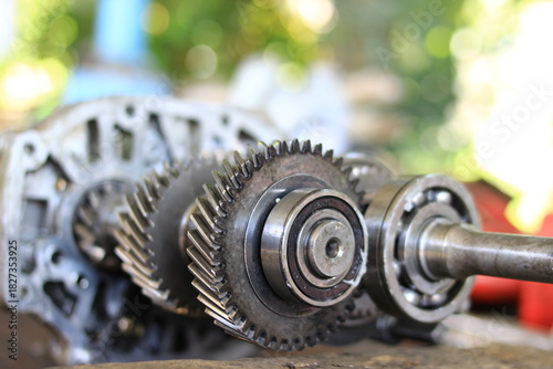 Gears or car parts being lifted out for repair.