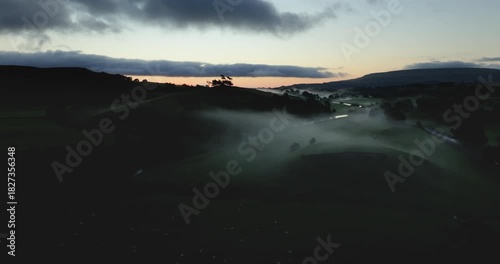 Flying over misty valley at dawn