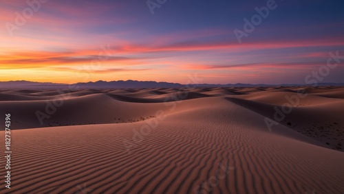 Fototapeta Naklejka Na Ścianę i Meble -  Sunset over desert sand dunes and mountain range