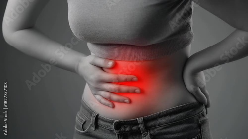 A young woman holds her stomach because she is in pain. Symbolic video for suffering due to illness or menstruation