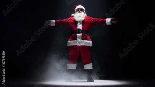 Santa claus in spotlight on dark stage with smoke against black background, concept of dramatic performance and showmanship