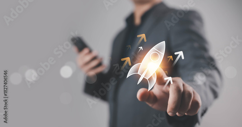 A business hand launching a glowing rocket icon, symbolizing startup growth, innovation, leadership, success, and forward progress, representing modern business strategy and digital transformation