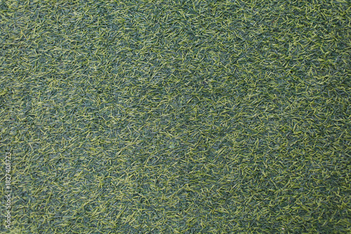 Close-up photo of green artificial grass suitable for use as a background.