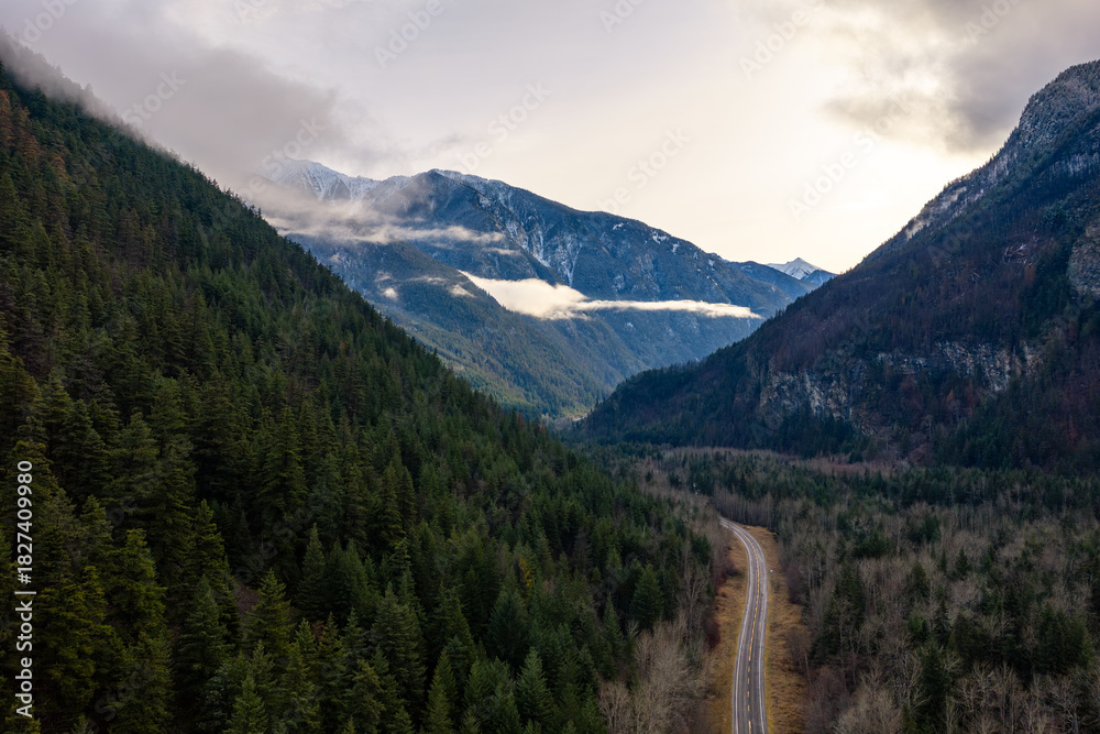 Fototapeta premium Winding Mountain Road Through Dense Forest Valley in British Columbia, Canada