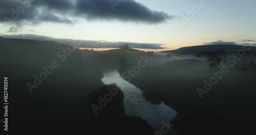 Flying over misty valley