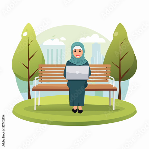 Woman in hijab sitting on bench using laptop in park.