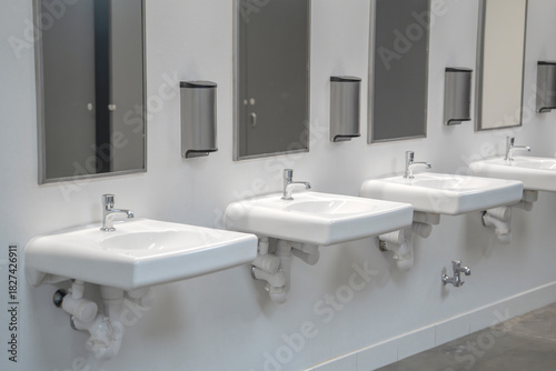 sinks in a row in public bathroom