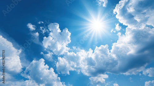 A radiant sun illuminates the sky casting light over soft white clouds. It is a clear day showcasing the beauty of nature in full display and inviting outdoor activities.