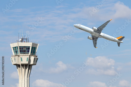 Photography Air control tower and airplane on blue and cloudy sky background