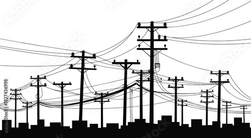 Black silhouette of numerous telephone poles and tangled wires over city buildings electricity