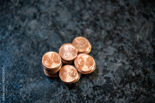 Obraz na płótnie Top down view of pennies on black marble