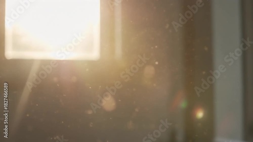Bright light shining through a window with dust particles floating in the air creating a soft glow