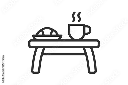 Minimalist breakfast in bed with steaming coffee and pastry on a small table