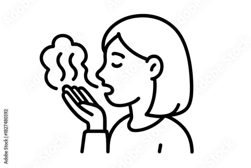 Woman exhaling hot breath or steam onto her hand to check for bad odor or warm up hands in cold weather