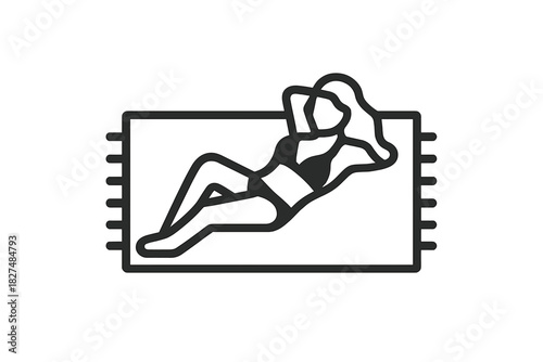 Woman relaxing and sunbathing on a beach towel during summer vacation