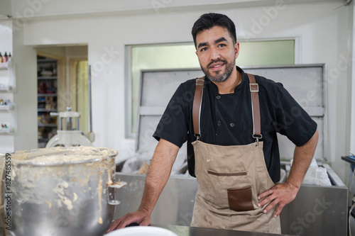 Latino man working as baker in kitchen