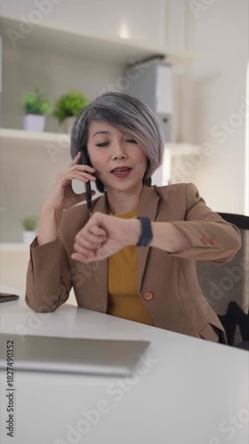 Asian older businesswoman presents data chart during online video call meeting explains business growth strategy remote work professional office conference