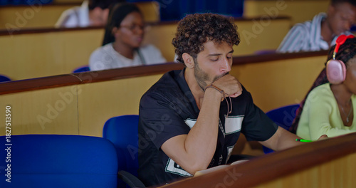 Vászonkép Indian young adult gen z dull lazy tired male man do yawning feel bad lack of energy sitting on desk table