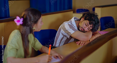 Valokuva Indian young adult gen z dull lazy tired male man feel bad lack of energy fall asleep take nap on desk table