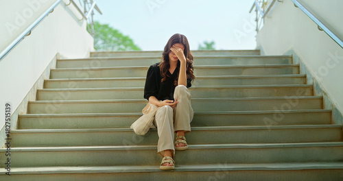 Indian young adult gen z upset female sitting alone on stair failed in exam feel bad low at campus place. Sad tense teen girl suffer course study have learning issue stress hostel life