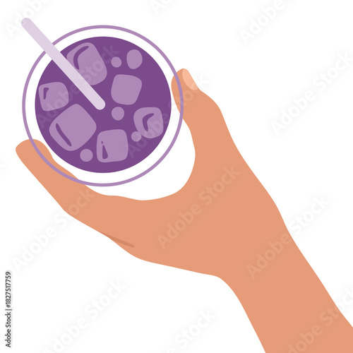Top view of Hand holds glass of purple juice with ice and straw, top view. Refreshing beverage concept for summer drinks.