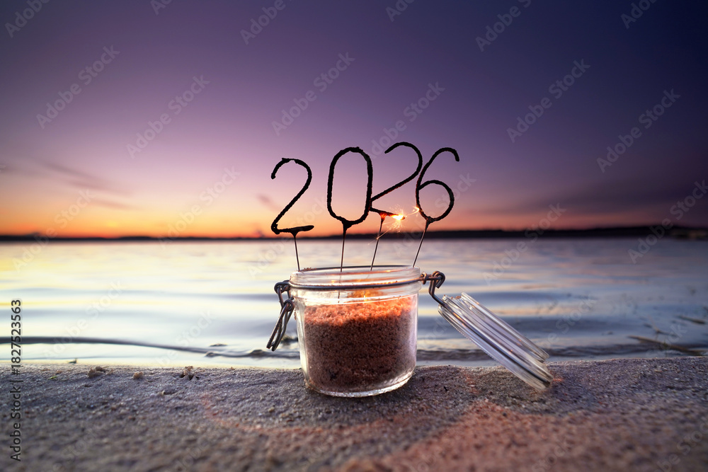 Obraz premium Burned down 2026 Sparklers in a Glass by the Sea